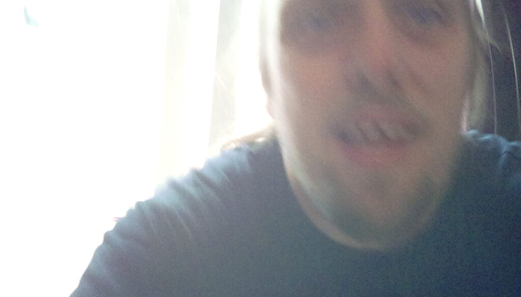 Extremely blurred close-up photo of Dan's face.