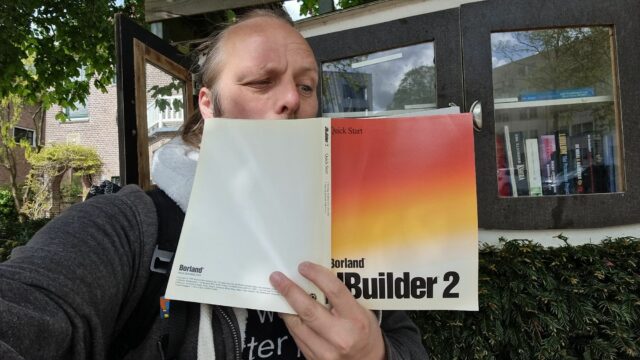 Dan squints into a copy of a book, Borland JBuilder 2 Quick Start.